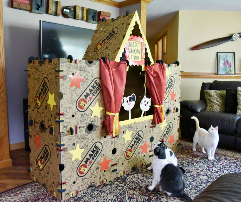 Cats watching puppet show in Make-A-Fort theater