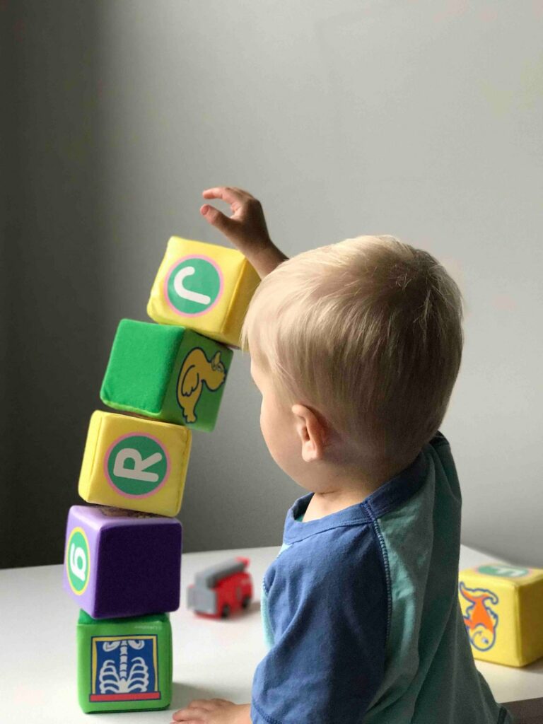 Toddler using blocks as Building Toys